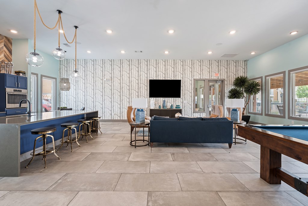 A modern living room with a pool table and a television.