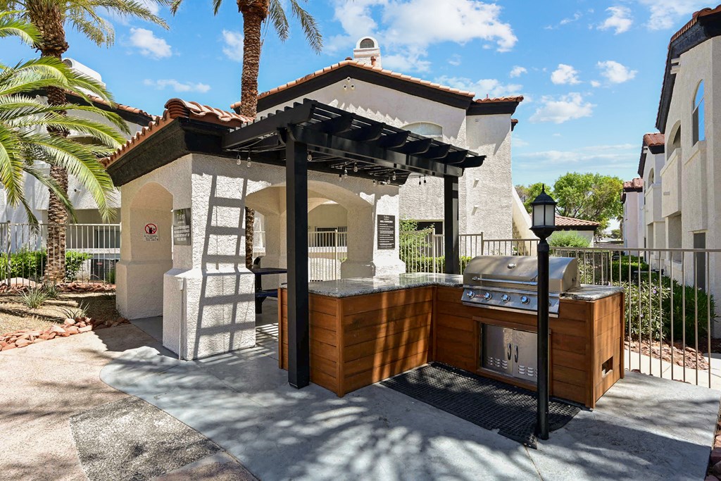 an outdoor kitchen with a barbecue