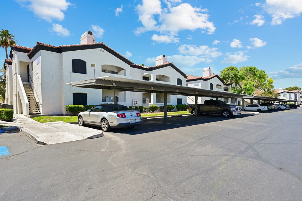a large white building with a parking lot in front of it