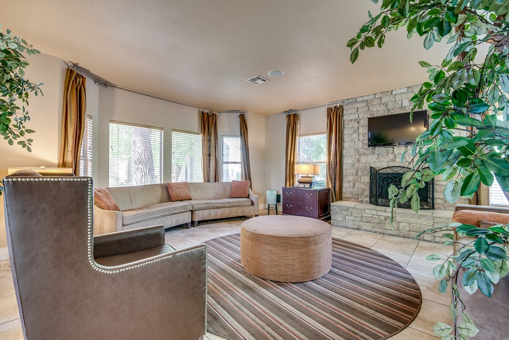 a living room with couches and a table and a fireplace