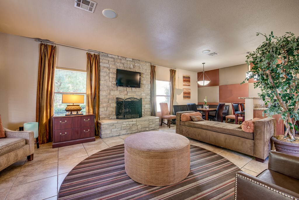 a living room with a stone fireplace and couches