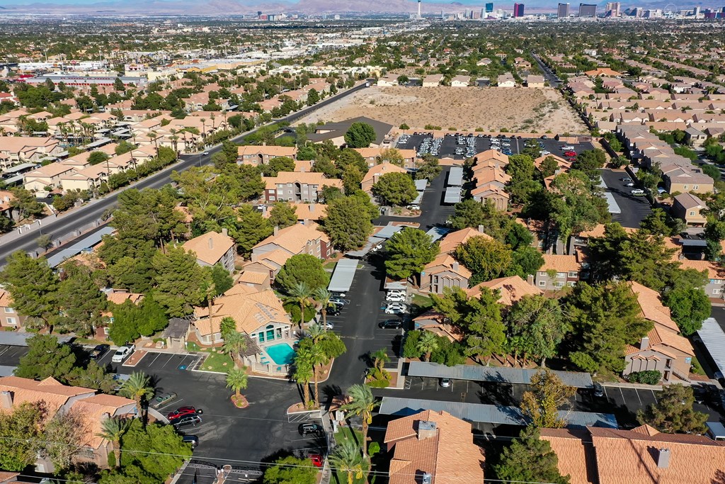 an aerial view of a neighborhood with houses and trees and a parking lot