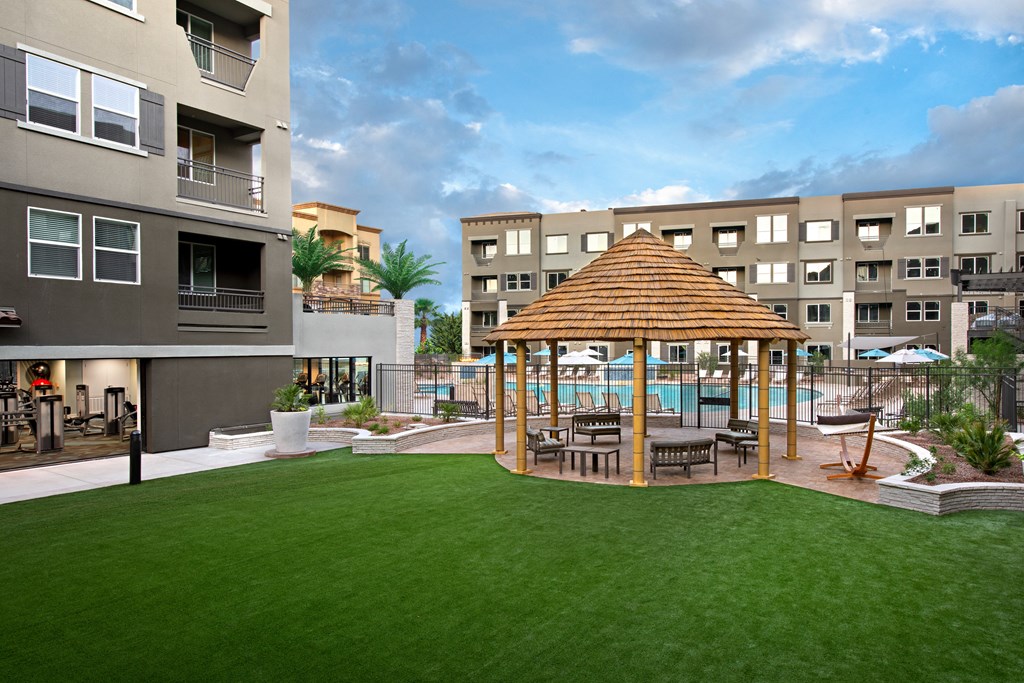 a patio with a gazebo and a pool at a hotel