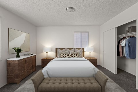 A bedroom with a large bed and a wooden dresser.