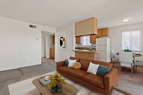 A living room with a brown couch and a coffee table.