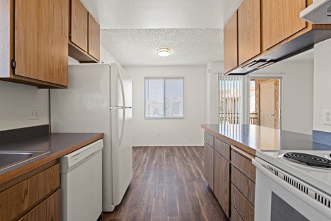 A kitchen with wooden cabinets and white appliances.
