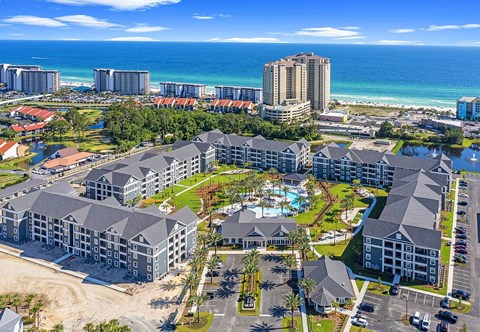 an aerial view of the resort with the ocean in the background