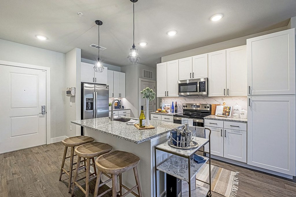 a kitchen with white cabinets and a counter top