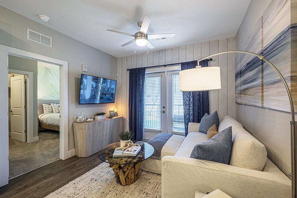 a living room with a couch and a ceiling fan