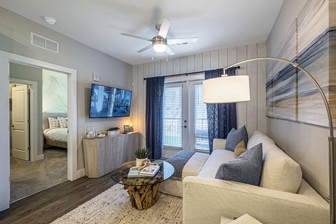 A modern living room with a white couch and a coffee table.