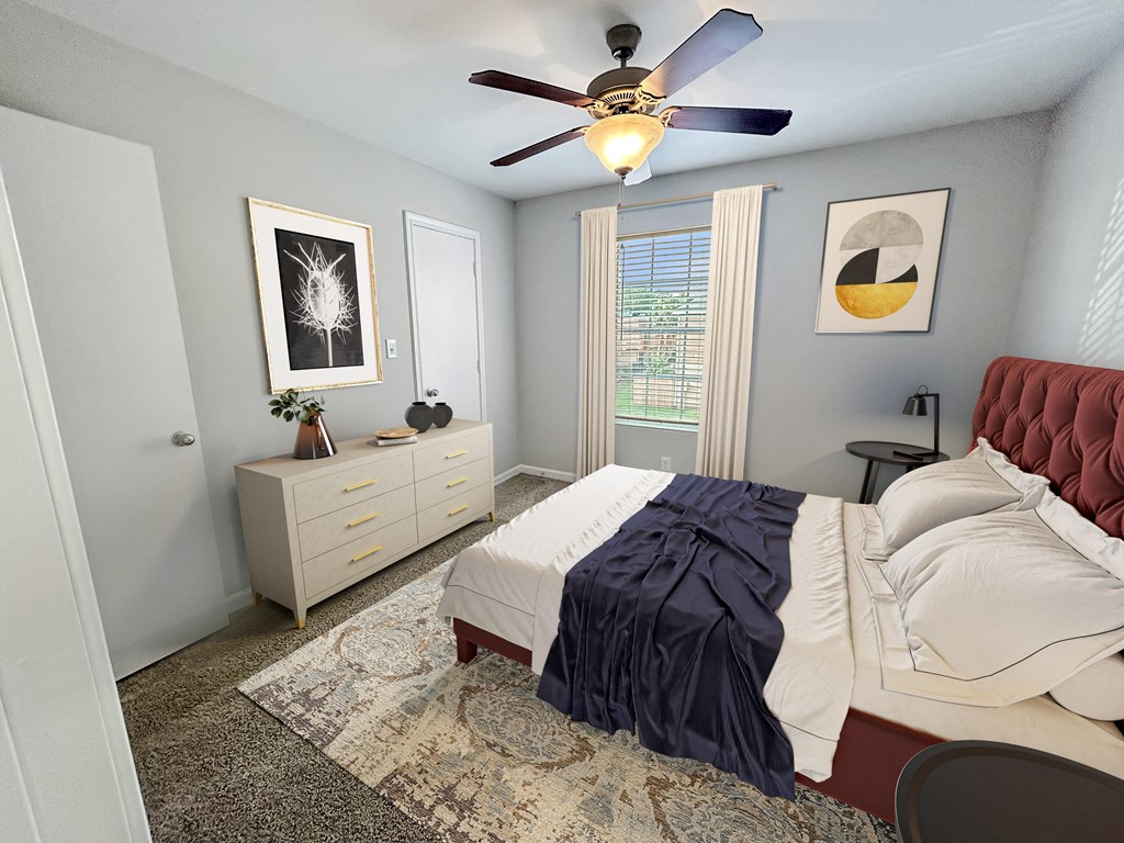 a bedroom with a bed and a ceiling fan