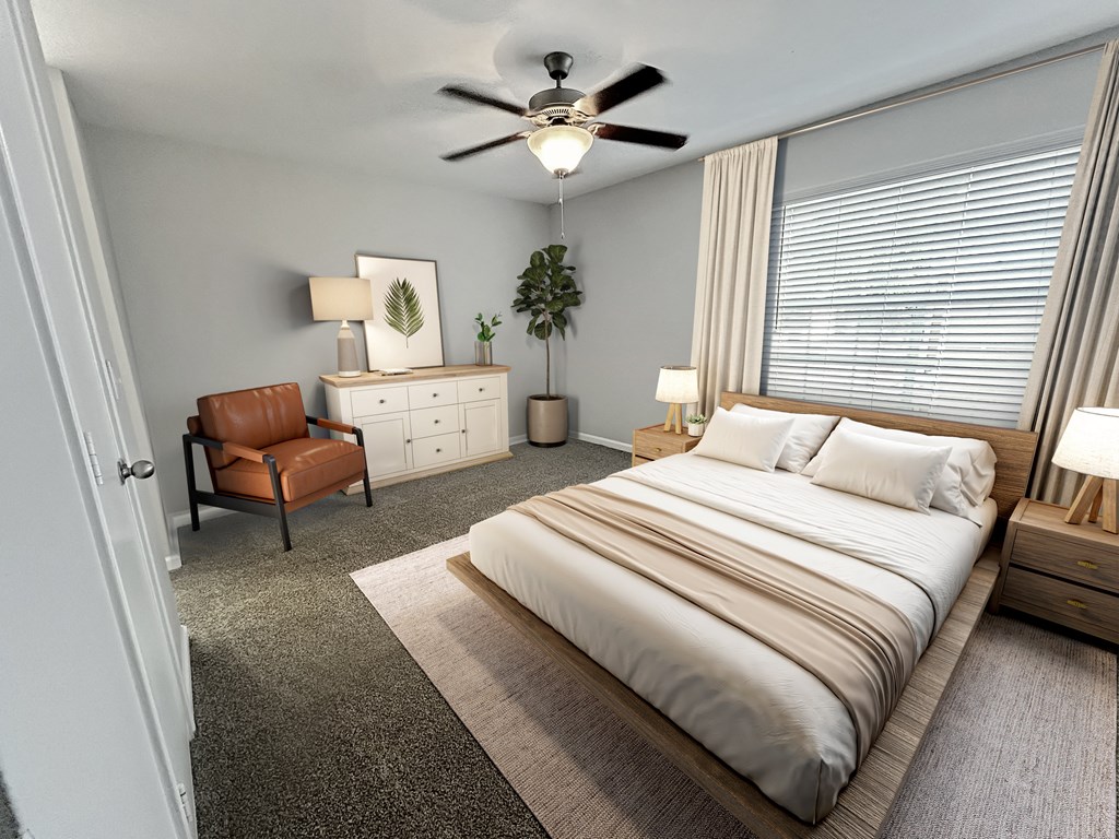 a bedroom with a large bed and a ceiling fan