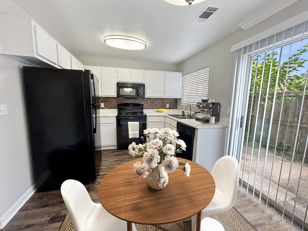 a kitchen and dining room with a table and chairs