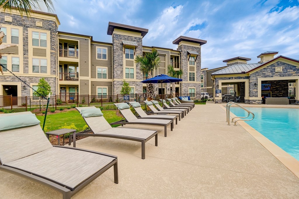 Outdoor sparkling pool with lounge chairs