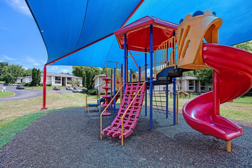 a playground with a slide and climbing equipment