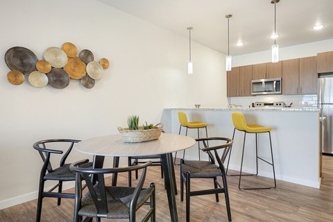 A modern dining room with a round table and chairs.