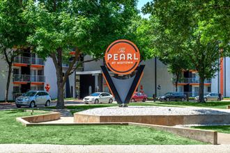 a sign for the pearl in front of a building