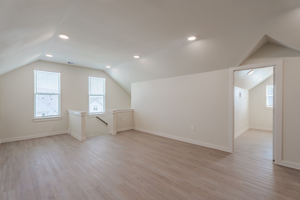 A room with wooden floors and white walls.