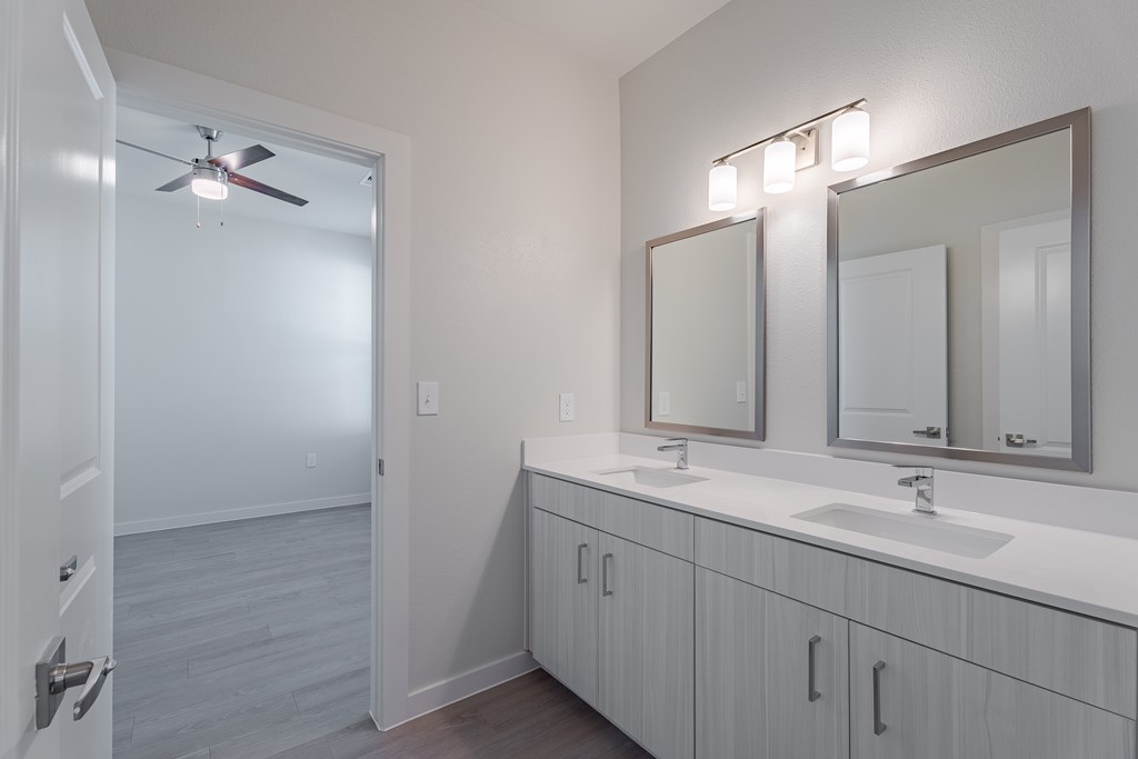 A bathroom with a white sink and a white door.