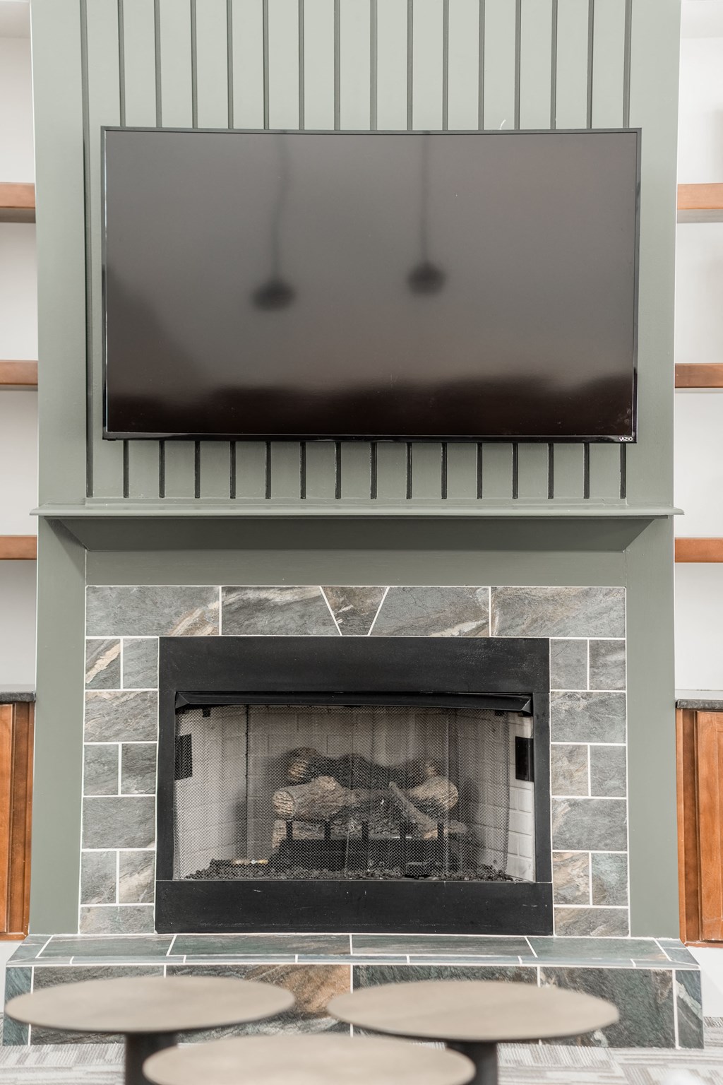 a fireplace with a tv above it in a living room