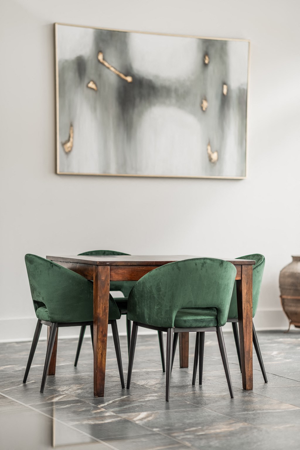 a dining room with a wooden table and green chairs