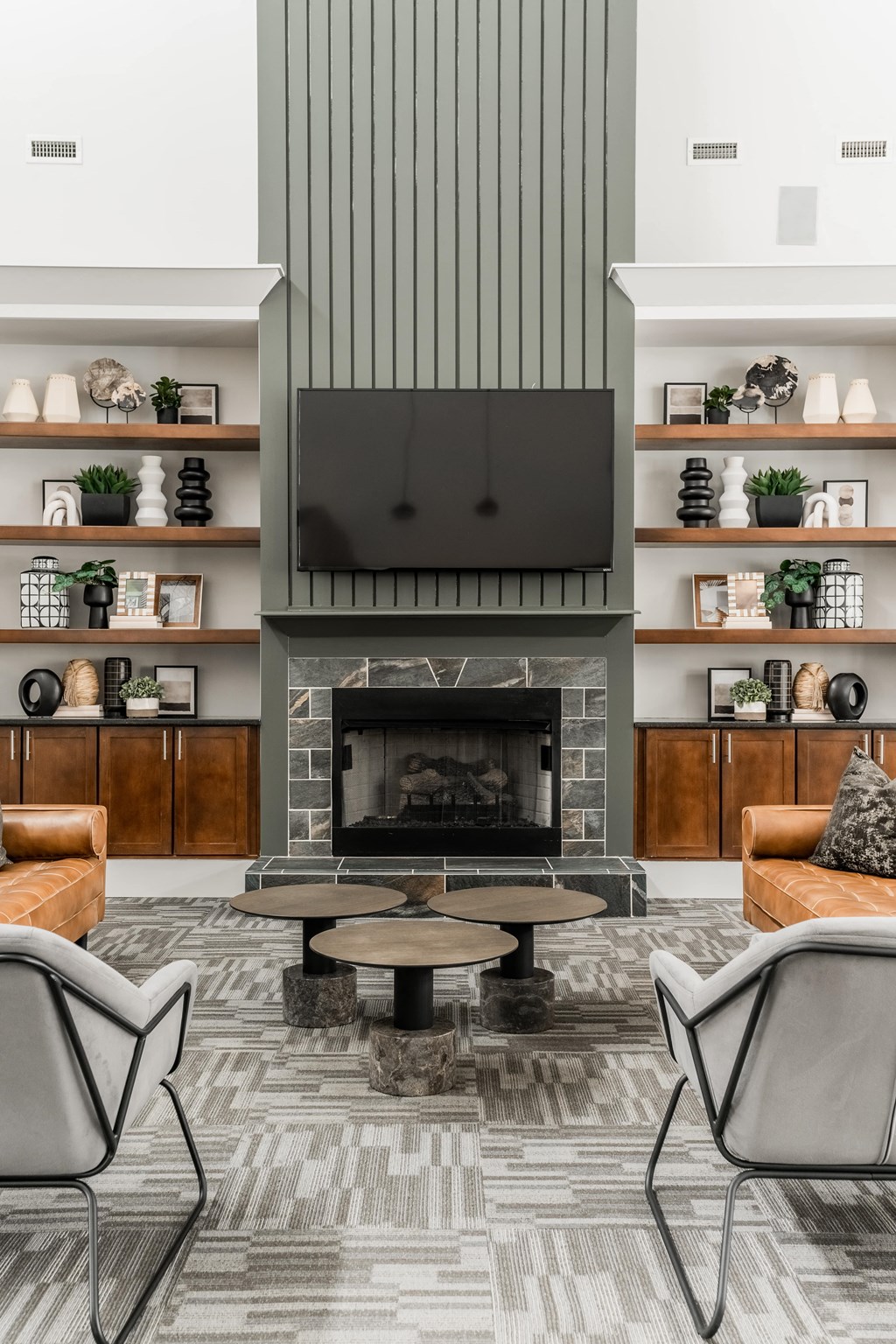 a living room with a fireplace and a tv above it