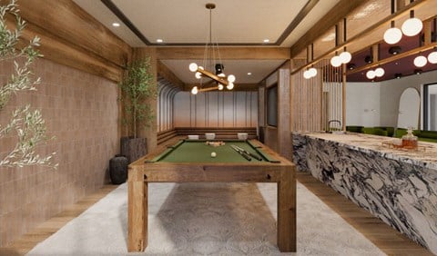A pool table in a room with wooden walls and ceiling.