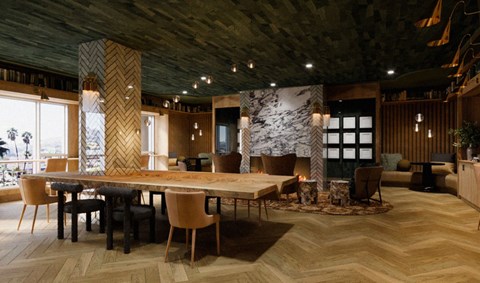 A modern dining room with a large table and chairs.