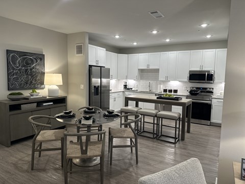 A modern kitchen with a dining table set for four.