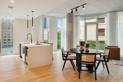 A modern kitchen with a dining table and chairs.