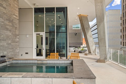 A modern outdoor space with a pool and seating area.