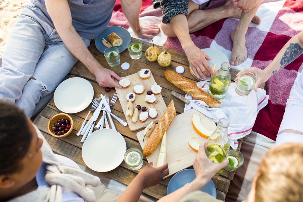 a group of people sitting around a table eating food