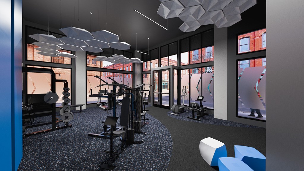 A gym with a row of treadmills and a row of exercise bikes.