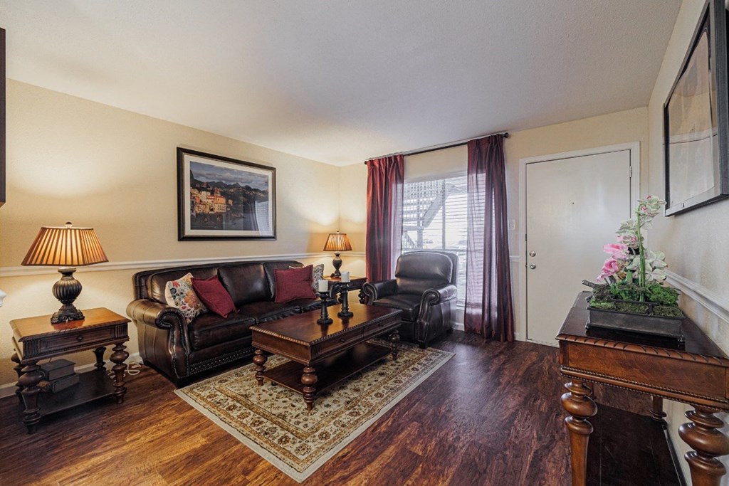 a living room with a leather couch and a coffee table