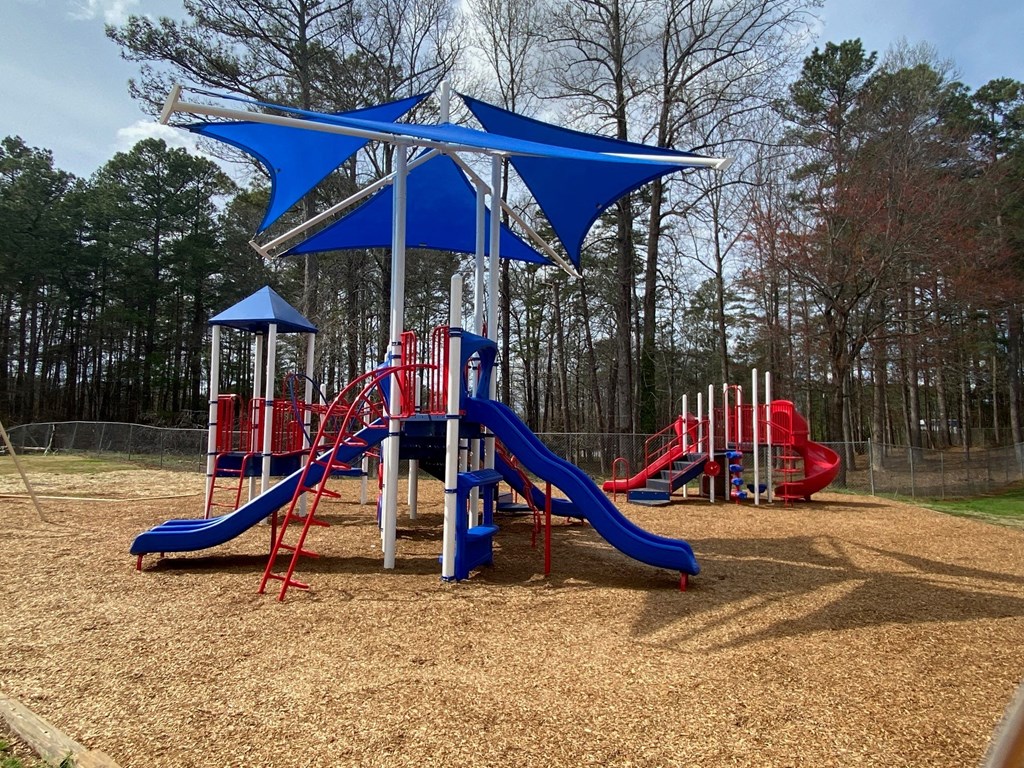 the playground at the park has several slides and swings