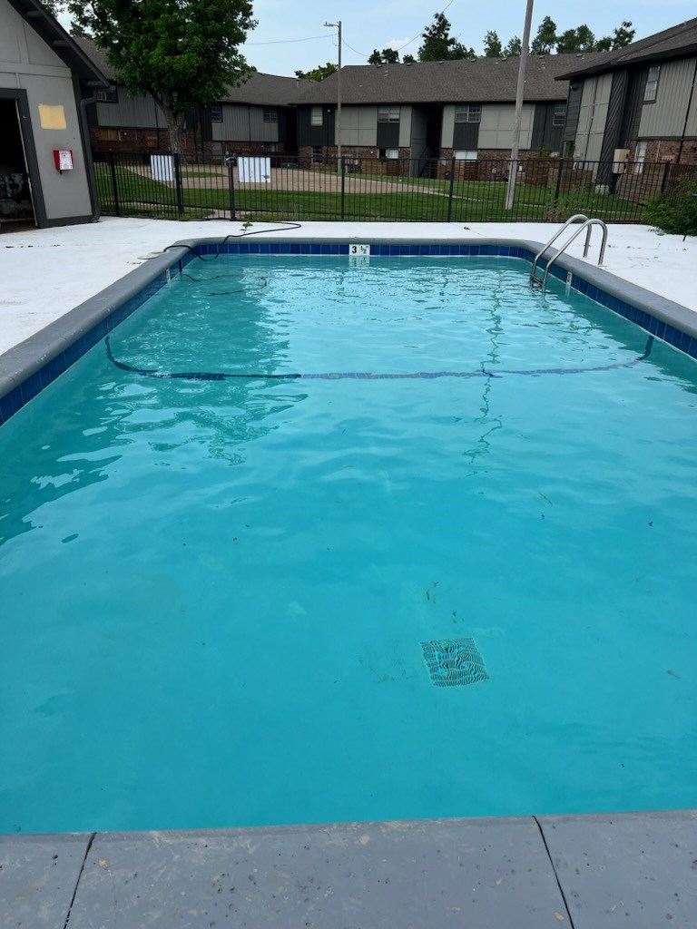 A small empty pool with a blue tiled edge.