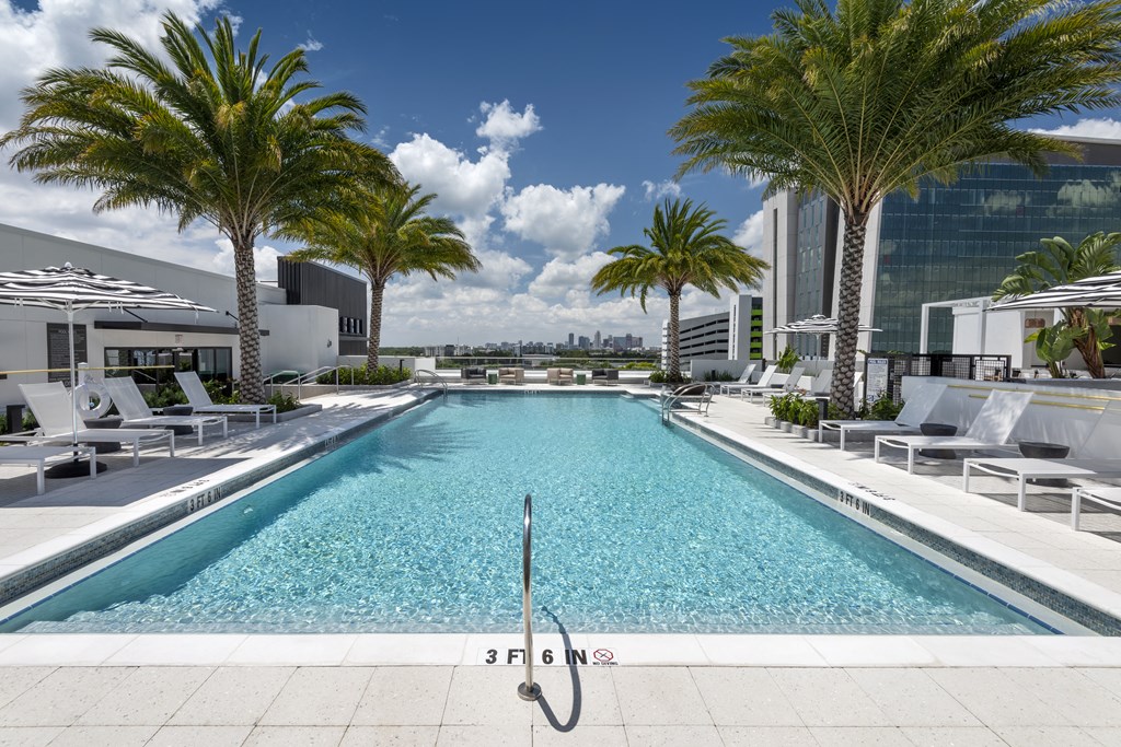 a swimming pool at a hotel with palm trees