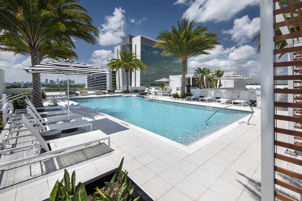 a swimming pool at a hotel with palm trees