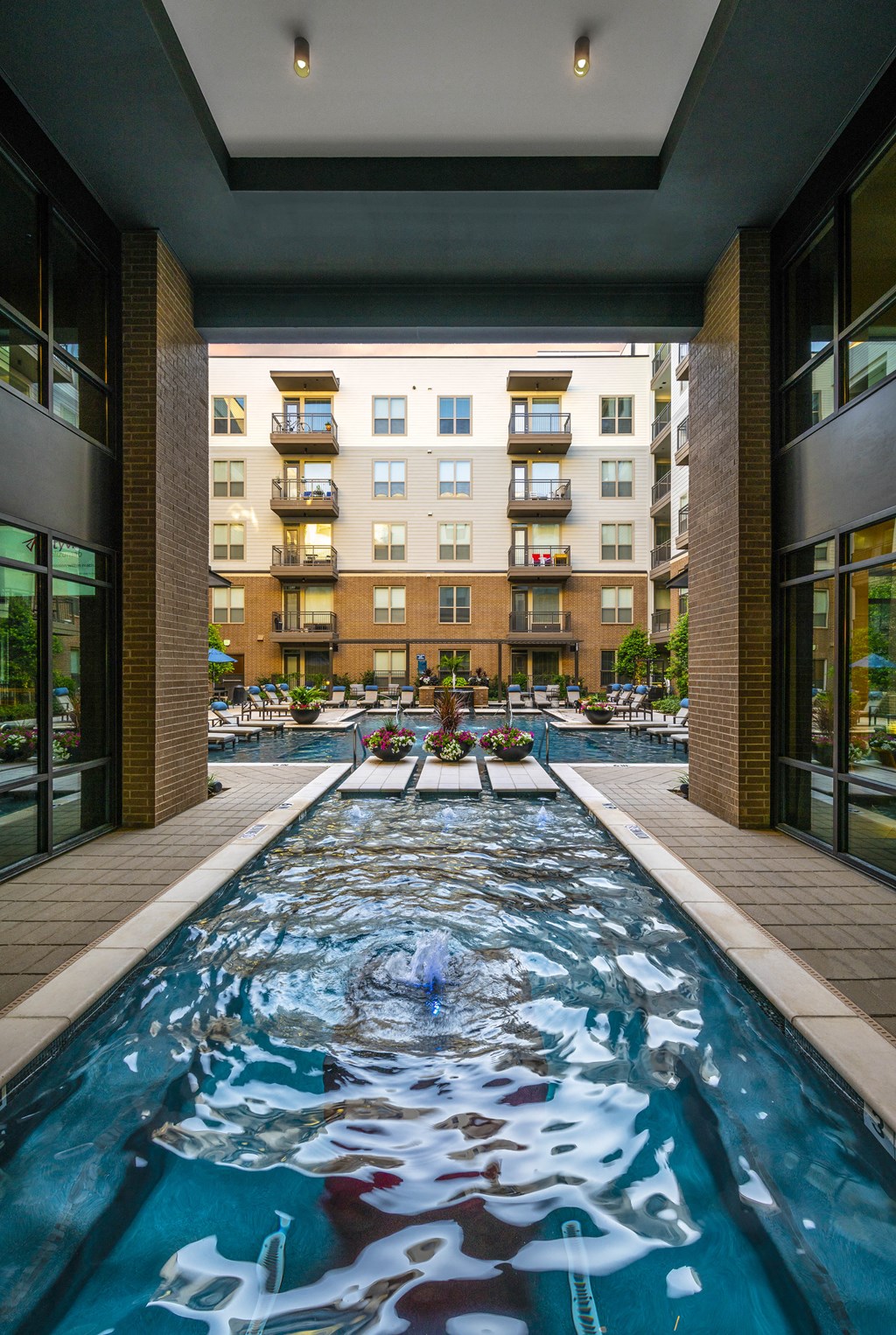 a swimming pool with a view of an apartment building in the background