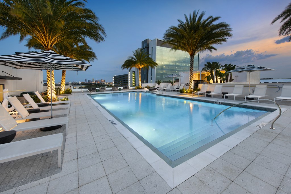 a swimming pool at a hotel with palm trees