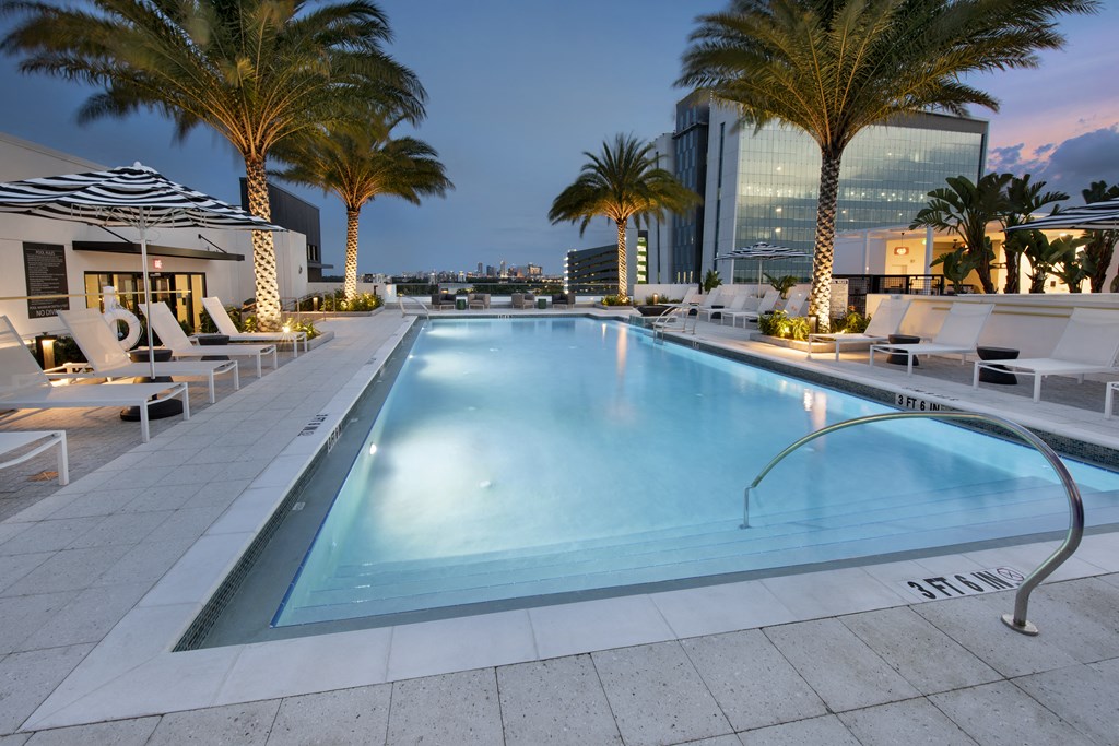 a swimming pool at a hotel with palm trees