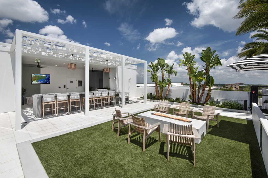 a rendering of a patio with a table and chairs under a canopy