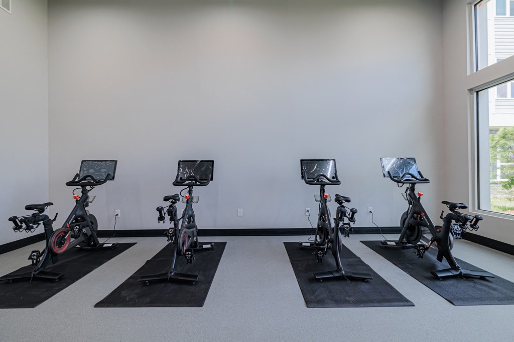 a row of exercise bikes in a room
