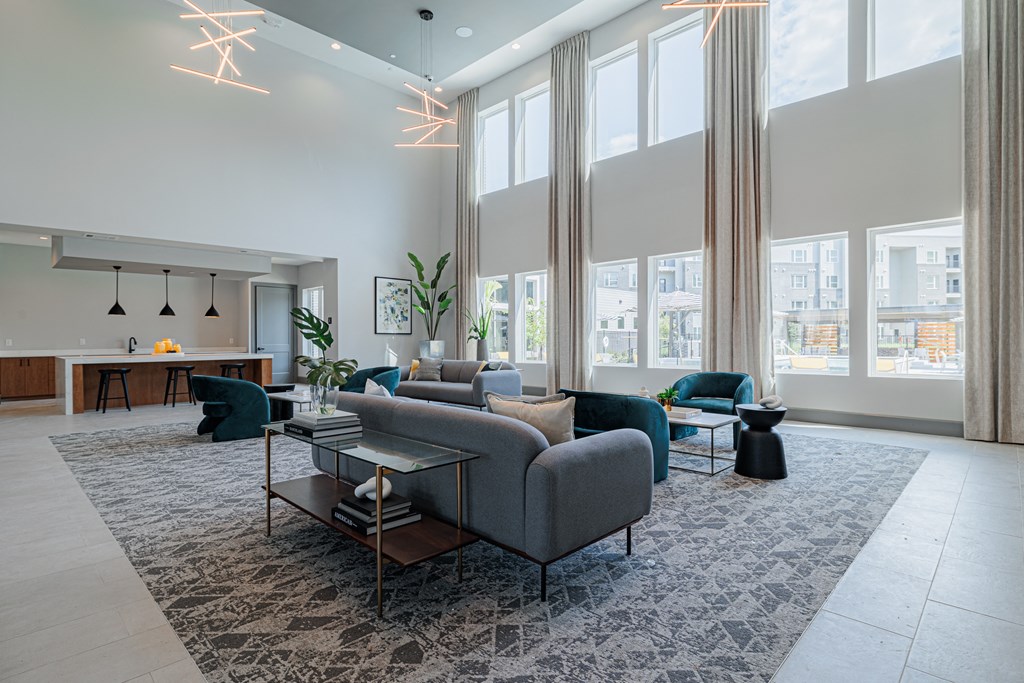 a living room with large windows and a large rug