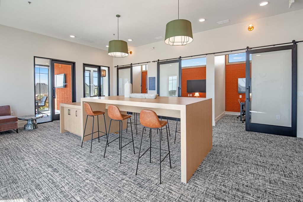 an open office space with a large counter and chairs