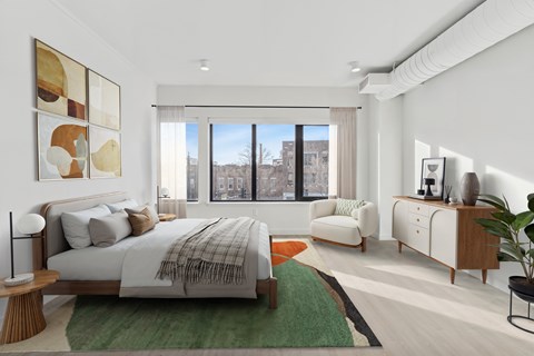 A bedroom with a large bed and a view of the city.