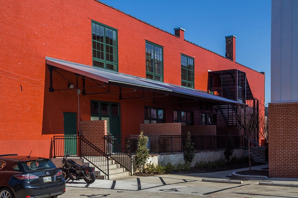 a red brick building with a blue awning in front of it