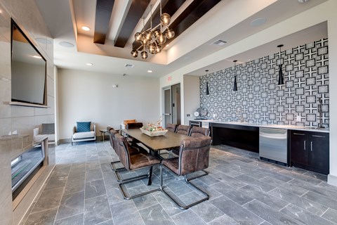 A modern dining room with a stone table and chairs.