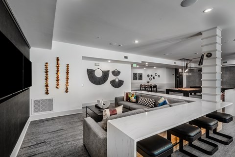 A modern living room with a white sofa and a grey couch.