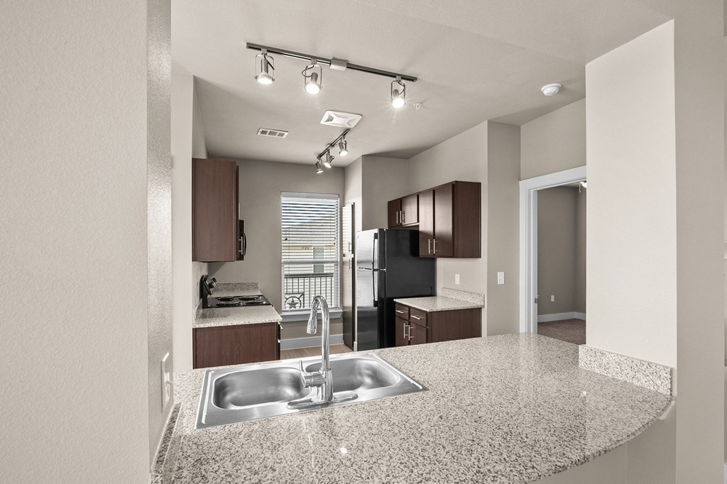 a kitchen with a granite counter top and a sink